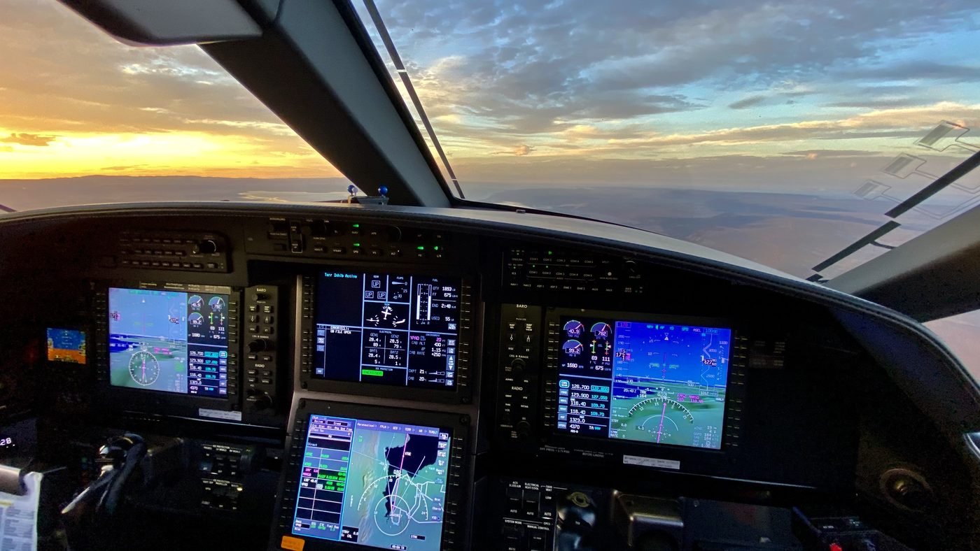 Cockpit view over landscape at sunset